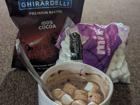 Ghirardelli baking cocoa, marshmallows, and a mug